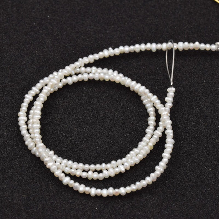 Weiße Kartoffel-Süßwasserperle 1–1.5 x 2–2.5 mm (1 Strang – 39 cm)